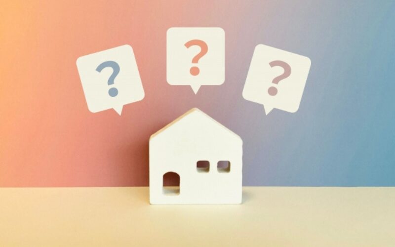 家を売る最適なタイミングや方法など、多くの疑問や悩みを表現した、家の模型と疑問符の吹き出し
